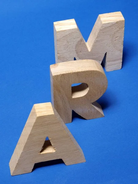 alphabet wooden letters on blue surface, abc symbolism