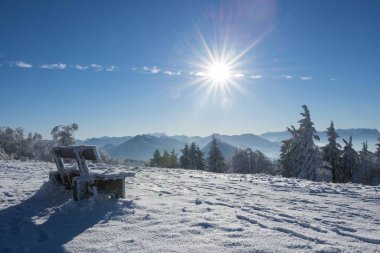 Winter bench in front of Alps on a sunny day, Gaisberg, Salzburg, Austria, Europe clipart