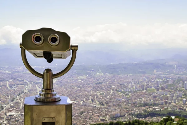 Coin-operated binoculars for watching the city. Panoramic city landscape.
