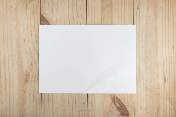 White paper on wooden background