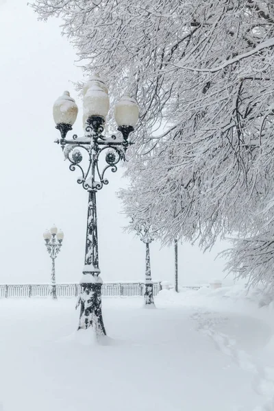 Street lamps covered in deep snow