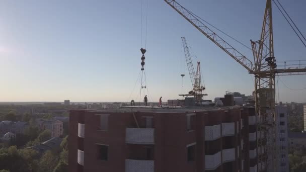 Aerial view of building cranes and buildings under construction — Stock Video