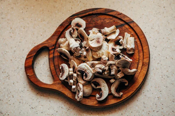 Sliced champignons on a cutting board. View from above. — Stock Image Sliced champignons on a cutting board. View from above. Stock Image
