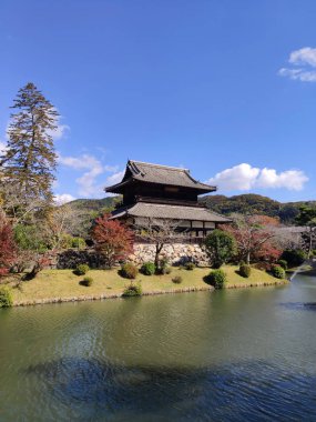 İwakuni, Japonya - 14 Kasım 2019: Kinunkaku Sarayı (yaklaşık Xix c.) İwakuni kalesi yakınlarındaki Kikko tapınağı. Pavilion eski kale hendeğinin yanında ve kale kulesine benziyor.