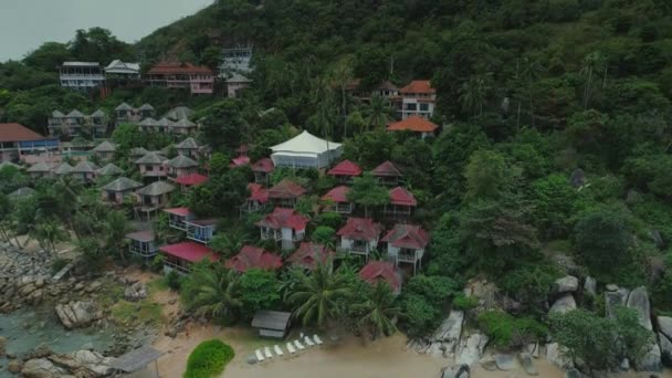 Thailand sea islalnd beach houses drone flight, wild mountains nature tree and palm hotel resort — Stock Video