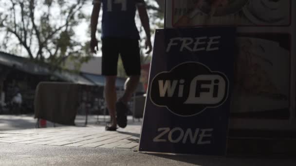 Ingyenes wi-fi poszter utcai ázsiai népek autók kerékpárok jel, jelkép — Stock videók