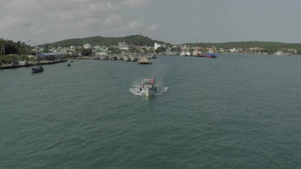 Fishing boat comes out of the harbor in Vietham harbor Sea port — ストック動画