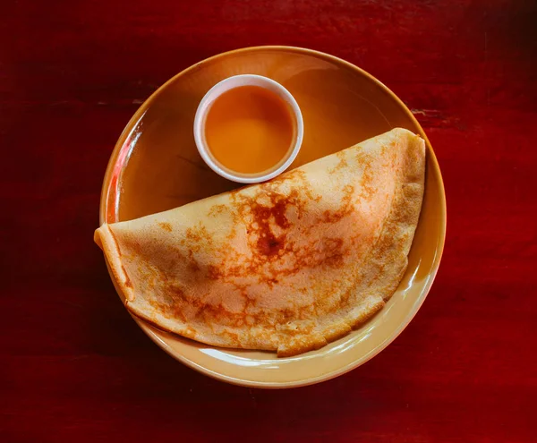 Tortitas sabrosas con miel dulce en un plato de barro — Foto de Stock