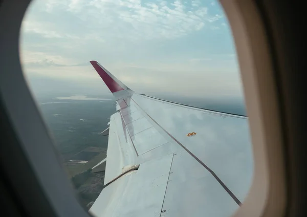 선실에서 비행기 날개 위에 있는 보조 비행기 윈도우 뷰, 스카이라인 수송 — 스톡 사진