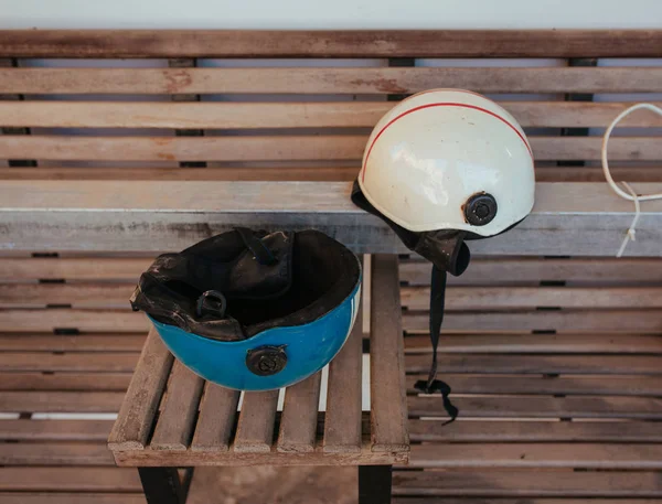 Bike Helmets on wooden bench in Asia — Stock Photo, Image