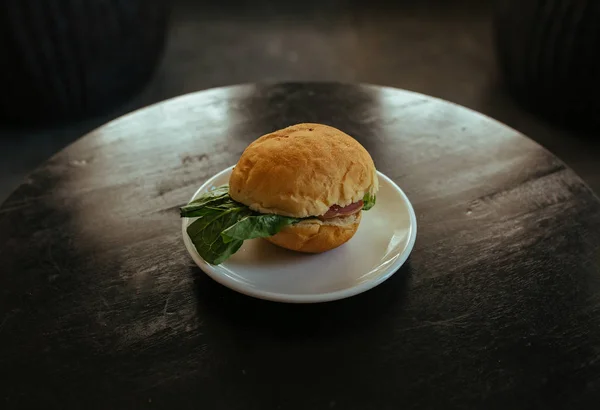 stock image Tasty Hamburger with ham and salad on the table