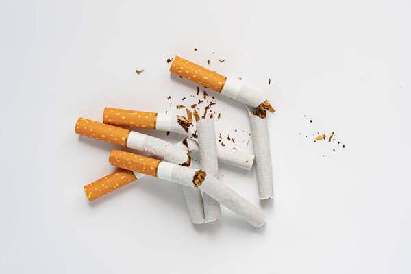 a no tobacco day, a broken cigarette on color background isolated on color surface, stop smoking