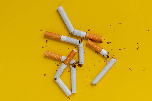 a no tobacco day, a broken cigarette on color background isolated on color surface, stop smoking