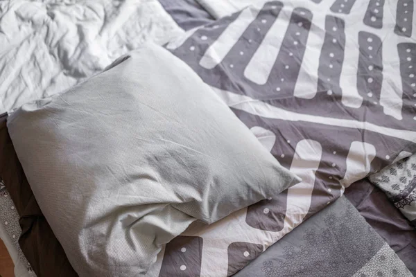 bed maid up with a simple abstract pillow design on top