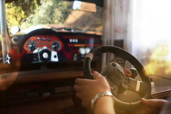 man learns how to drive the car on the virtual driving auto simulator