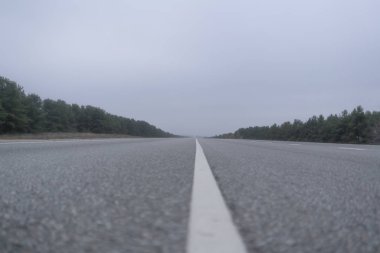 Sis yağmurlu havada kırsal kesimde soyut otoyol. Tehlikeli sürüş, kaza araba kazası