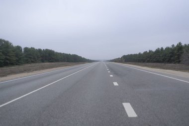 Sis yağmurlu havada kırsal kesimde soyut otoyol. Tehlikeli sürüş, kaza araba kazası