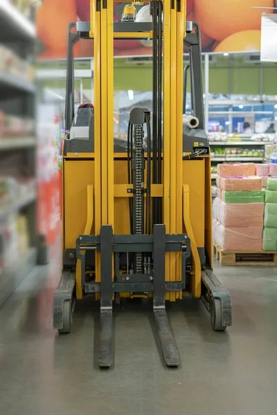 forklift in the warehouse working and lifting the boxes of new income products