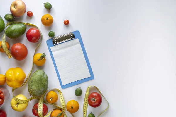 a flat lay of the blank paper sheet mockup for the diet plat recipe, raw fresh fruit on table