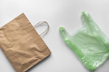 paper cotton eco versus plastic package flat lay. environmental global problems concept