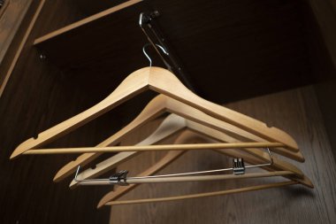 a some empty wooden hangers inside the home vintage wardrobe
