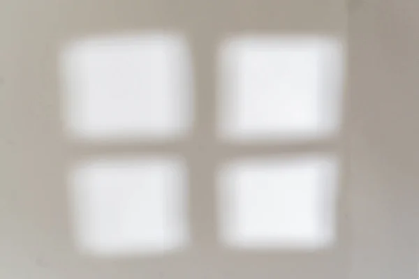 Out of focus abstract window cross shadow on the wall in the morning — Stock Photo, Image