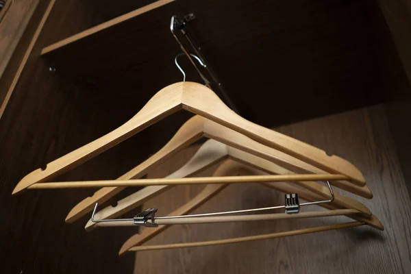 A some empty wooden hangers inside the home vintage wardrobe — Stockfoto