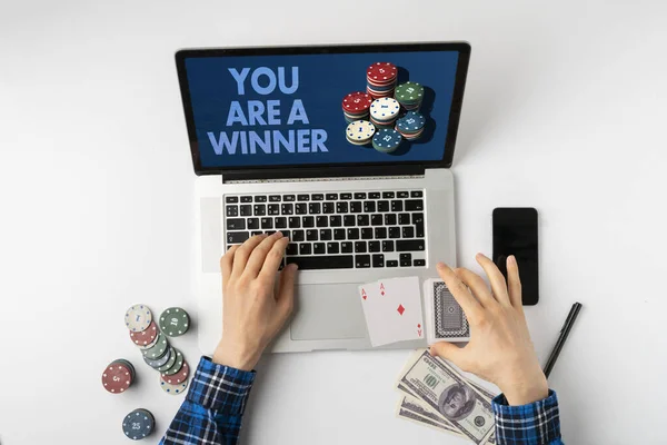 A overhead person playing the gamble games online at home and win the money, the stack of chips on the gadget screen — Stock Photo, Image