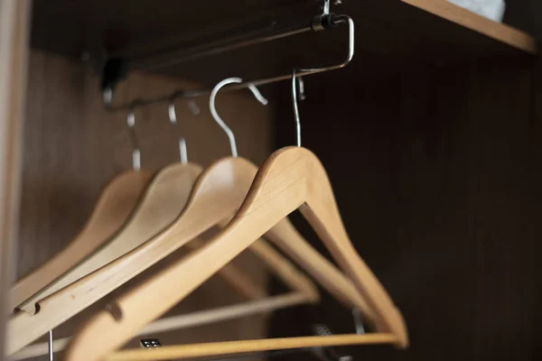 A some empty wooden hangers inside the home vintage wardrobe — 图库照片