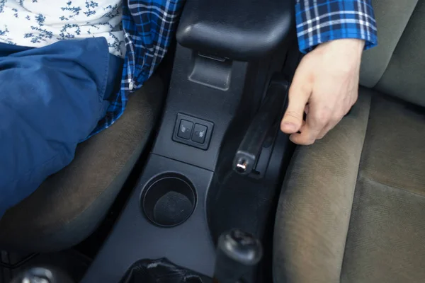 司机坐在车内 用手动式制动器把双手合拢起来 — 图库照片