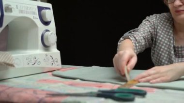 female tailor line clothes with soap or chalk