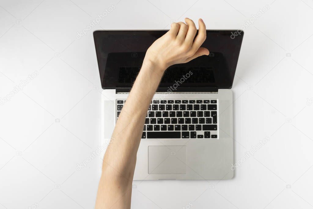 top view of person hands close cover or block the laptop webcam, being afraid of spy hack the camera