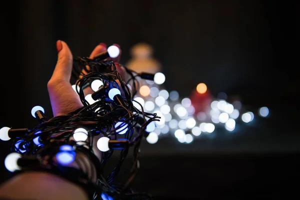 Christmas light bulbs in hands