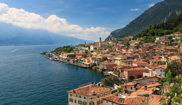 Panoramic view of small town Limone sul Garda at Lake Garda west shore on a sunny day in springtime