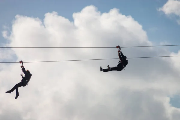 People having fun using a zip line — Stock Photo, Image