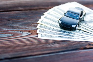 Tahtada birkaç dolar üzerinde siyah araba.