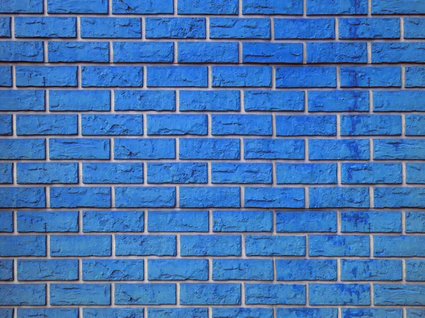 Wall of curly relief decorative blue brick texture background seamless