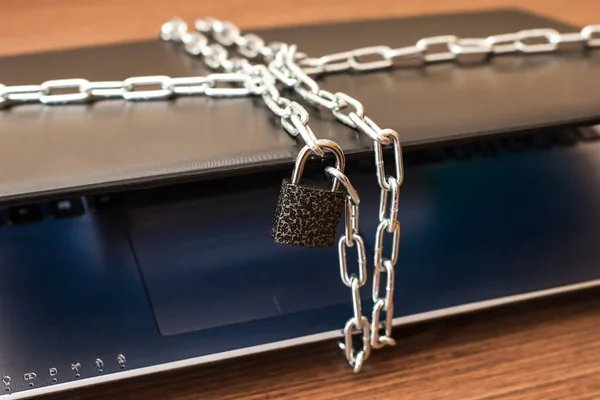 Laptop with chains and lock.