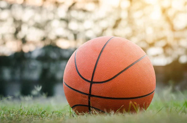 old basketball on green field