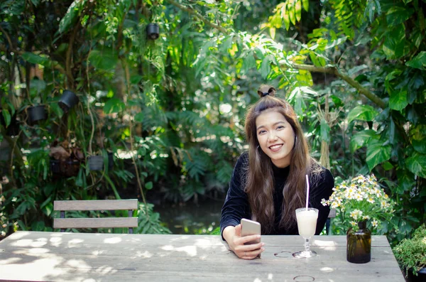 Taylandlı Kız Bahçede Akıllı Telefon Kullanıyor — Stok fotoğraf