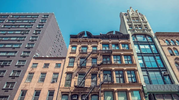 New York old buildings facade with fire escape ladder