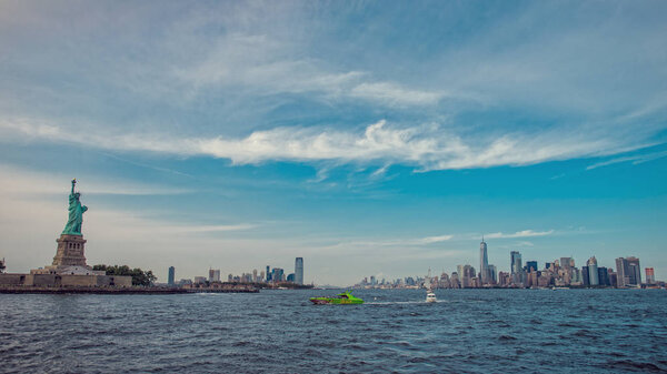 View of Statue of Liberty on New York City skyline at sunny day