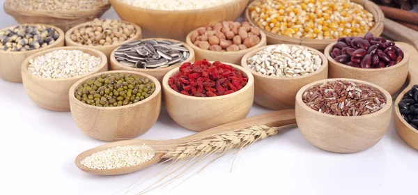 Cereal grains , seeds, beans on wooden background