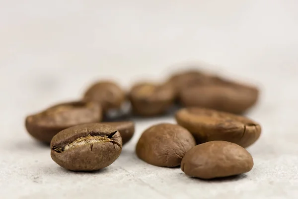 Roasted coffee beans - seeds - on light background - macro