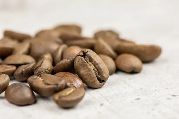 Roasted coffee beans - seeds - on light background - macro