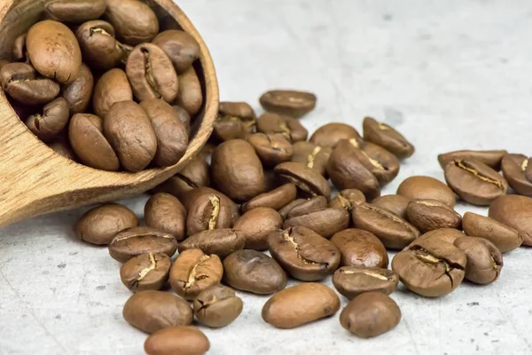 Roasted coffee beans - seeds - on light background - macro