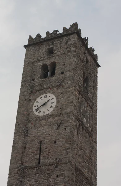 High italian church tower with bell and watch