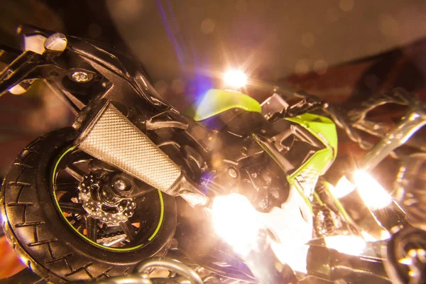 Green motorcycle surrounded by new year lights — Stock Photo, Image