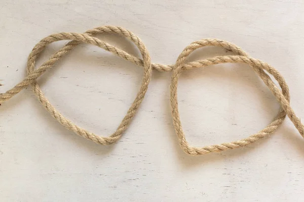 Two heart ropes connected to a knot — Stock Photo, Image