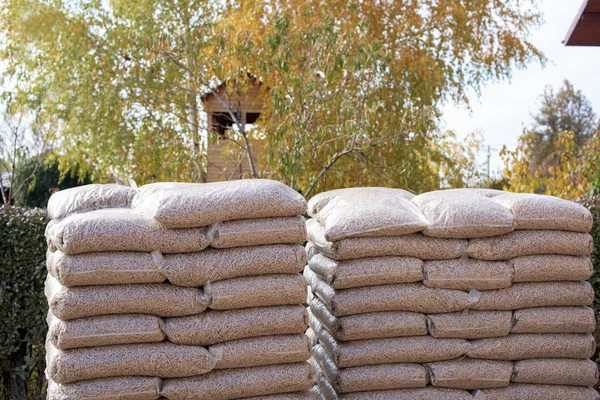 Två stora högar med säckar med biomassa — Stockfoto